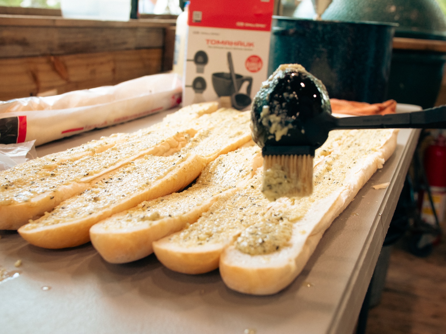 The GrillSpec TOMAHAÜK being used to baste food during a live-action product demonstration